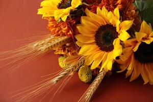 A stunning bouquet of sunflowers and wheat, a perfect representation of autumn. photo