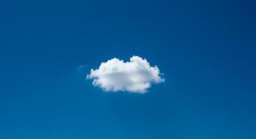 A single cloud floating in the blue sky photo