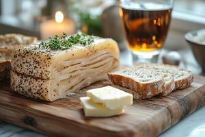 Icelandic fermented shark, hakarl, served on a wooden board, accompanied by rye bread, butter photo