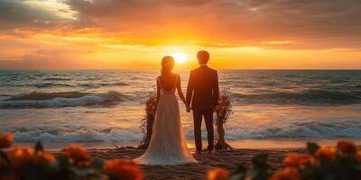 a sunset wedding by the beach, the couple standing under a driftwood arch decorated with flowers, waves gently rolling in, blank right side for copy space photo