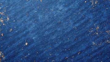 Textured Blue Denim Fabric with Distressed Elements and Wear Patterns photo