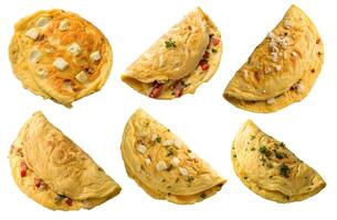 Omelets with varied fillings including cheese and vegetables prepared for breakfast or brunch on a white background photo