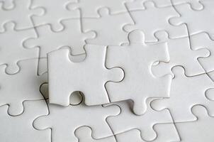 Close up of jigsaw puzzle pieces with customizable space on jigsaw for text or ideas photo