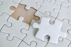 Close up view of interlocking jigsaw puzzle pieces symbolizing problem solving teamwork and collaboration. photo