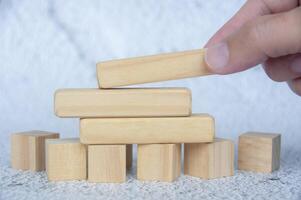 Straight view of wooden blocks with customizable space for text with hand background. Copy space concept photo