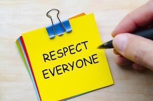 Respect everyone text on yellow sticky notes representing equality and kindness in daily interactions photo