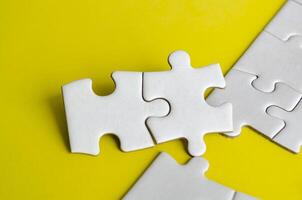 Close up view of interlocking jigsaw puzzle pieces symbolizing problem solving teamwork and collaboration. Solution concept photo