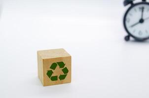 Recycle symbol with wooden blocks on a white background. Promoting reuse, reduce, and recycle for sustainability. photo