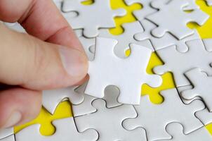 Close up of hand place missing jigsaw puzzle representing problem solving skill photo
