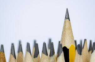 A pencil standing out from the rest representing Courage or Leadership with customizable space for text photo