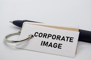 Corporate image label on white notepad representing business branding and company perception. photo