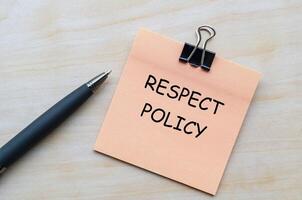 Respect policy text on pink notepad representing guidelines for ethical and respectful conduct. photo