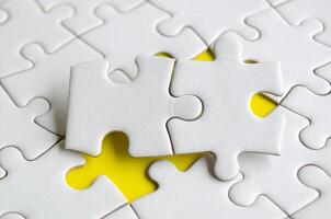 Macro view of empty white jigsaw puzzle with customizable space for text or ideas photo