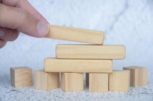 Hand placing wooden blocks with customizable space for text or ideas. Copy space concept photo