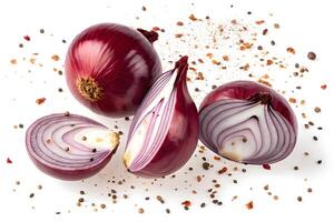 Sliced and whole red onions with scattered spices on white background. photo
