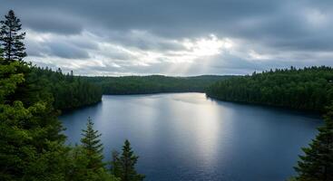 Serenity Reflected A Tranquil Lake Scene Under a Sky Veiled with Clouds photo