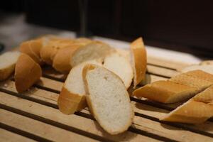 Sliced bread loaf Top view of sliced wholegrain bread on dark ructic wooden background closeup photo