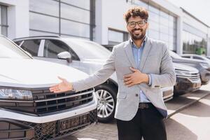 Car Salesman Showing New Vehicle to Potential Customer in Dealership photo