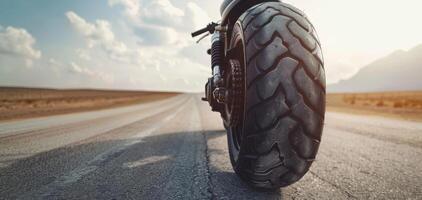 A motorcycle tire on the road with a sky background photo