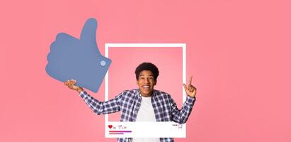A joyful individual gives a thumbs-up while posing in front of a pink background. The person's delight represents the active online community of bloggers and content creators celebrating engagement. photo
