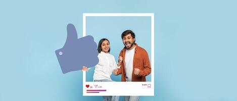 Two happy individuals express excitement while posing together in front of a light blue background. They give a thumbs up and seem to celebrate their success in content creation. photo