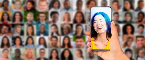 A person holds a smartphone displaying a joyful face recognition scan. The background features a collage of portraits highlighting diverse individuals, symbolizing advanced identification technology. photo