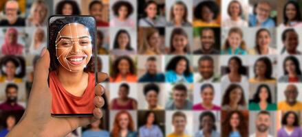 A person uses a smartphone to scan their face for identification. The background displays a collage of diverse faces, showcasing the capabilities of modern technology in personal identification. photo