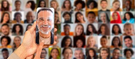 A hand holds a smartphone displaying a face recognition feature, while a collage of diverse faces appears in the background, showcasing the capability of modern identification technology. photo