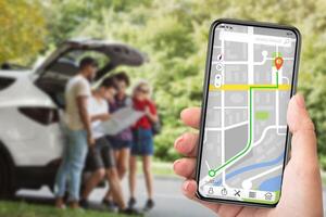 Geocaching Concept. Woman using smart phone with gps app on the screen, people looking at map in the blurred background photo