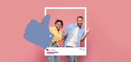 Two individuals pose joyfully in a playful manner, giving thumbs up with a vibrant pink backdrop. Their expressions reflect excitement, capturing a moment of celebration and connection online. photo