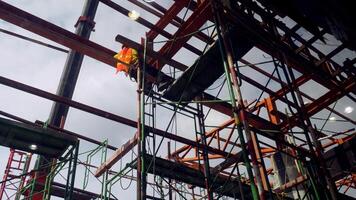 Construction Site with Steel Framework and Scaffolding Under Cloudy Sky, Highlighting Industrial Progress and Urban Development photo