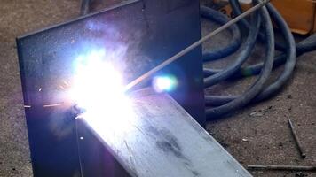 Close-Up of Welding Process with Bright Sparks and Metalwork in Industrial Workshop Setting photo