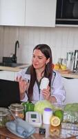 A nutritionist is communicating with patients via computer and demonstrating capsules with dietary supplements. Proper nutrition contributes to good health and vitality. Health concept, medical center video