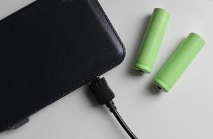 Portable Power Energy Sources. Rechargeable Batteries Near Charged Powerbank Isolated On White Top View photo