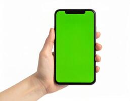 Hand gripping a smartphone displaying a green chroma key screen, empty mockup template photo