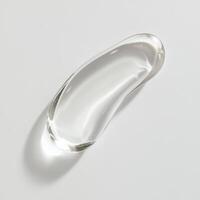 Single transparent glass stroke with smooth edges and glossy surface. Abstract fluid motion captured in minimalist 3D render on white background. Clean and modern visual concept photo