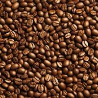 Overwhelming close-up of numerous roasted coffee beans densely packed, creating a uniform brown texture and suggesting abundance or a coffee bean harvest photo