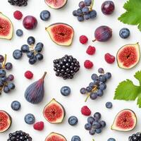 Flat lay of various berries and figs including blackberries, raspberries, blueberries, and sliced figs on a white background, creating a vibrant and textured fruit composition photo
