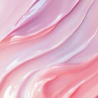 A vibrant, glossy pink cream texture flows in appealing waves. This abstract cosmetic background highlights the interplay of light and shadow, giving it depth photo