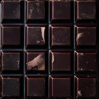 Overhead shot of a dark chocolate bar showing slight surface imperfections and peeling. A rustic, textured look photo