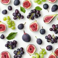 Top view of figs, green grapes, and dark plums scattered on a white surface, highlighting a mix of fresh, colorful, and juicy fruit photo