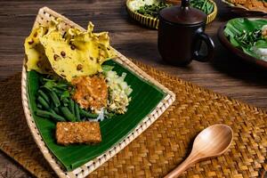 Authentic Javanese Pecel in Triangular Bamboo Plate With Wood Spoon photo