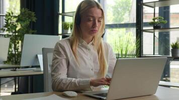 Overworked businesswoman operator talking client with computer headset business woman listening problem consulting customer helpline call service at office stressed girl manager talk online by laptop video
