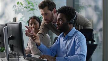 Callcenter Caucasian business boss men explaining African worker computer typing support advice Indian woman in headset multiethnic operators working call center online sell trading helpline at office video