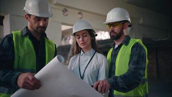 Caucasian team colleagues builders discuss blueprint building in construction guys foremen supervisors controlling industrial project draft site paper woman architects manufacturing handymen talking video