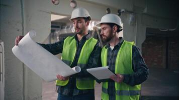 Professional Caucasian guys conversation holding paper blueprint in construction cooperation builders men engineers electricians draft technicians mechanics planning building colleagues manufacturing video
