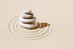 Zen garden meditation sandy background with stone cairn and lines on sand. Relaxation balance and harmon photo