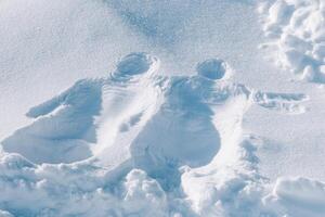 Print of human body on snow. Figure in snow from two bodies of man and woman. Winter entertainment photo