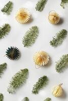 New Year Festive winter holidays concept, Minimal style top view aesthetic repeat pattern with beige paper ornaments, green Christmas tree-shaped ornament, natural fir tree branches, above view photo