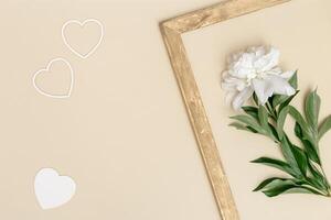 White peony and small hearts minimal pastel greeting card. Fresh fragrant peony flowers and vintage wooden frame photo